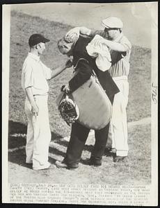 Ump Gets Relief From 101 Degree Heat -- Umpire Emmett (Red) Ormsby, like most other persons in Chicago today, got what relief he could during the 101-degree heat that prevailed as the Boston Red Sox and Chicago White Sox clashed. Here, trainer in Green (right) of the Boston club sponges Ormsby's neck between halves of the seventh inning while Sharkey College, White Sox clubhouse boy, holds a lemon to