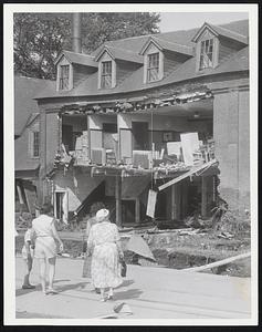 Westfield Home Wrecked- Residents of Westfield's east side inspect damage left by Powder Mill Brook, which tore the front wall out of this solid brick house. Damage in city was estimated at more than $1,000,000.