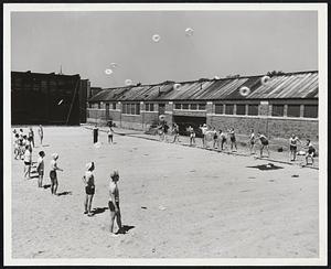 Getting Ready for the Beach Season -- Boston lifeguards are in training at L st., learning life-saving methods from Alex Houston, water safety director of the Boston Metropolitan Red Cross. Here they practice control of throwing life-saving rings. Beaches open in Boston, June 15th.