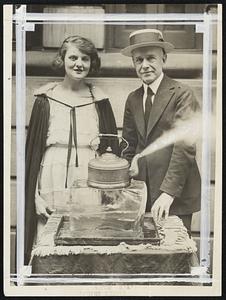 Cooking on Ice- Great On Hot Days. Here's a new household mystery. The water kettle is shown here boiling over, steam shooting out of the spout, and the kettle is not on a hot stove, but on a Cake Of Ice. Believe it or not, but here it is, and the ice is real. Fred Andrews, shown in the photo, is the originator of this new household hint, and Miss Viola May is the successful cook. Liquified oxygen is the secret. Liquid Oxygen is 312 degrees below zero, and 344 degrees below freezing temperature, hence the ice is intensely hot in comparison, and when the oxygen is placed in the kettle it boils merrily.