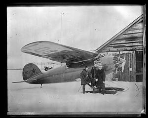 Hubert Wilkins with Ben Eielson, standing beside Lockheed airplane