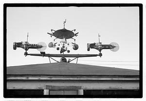 An elaborate device on roof, possibly a weather vane