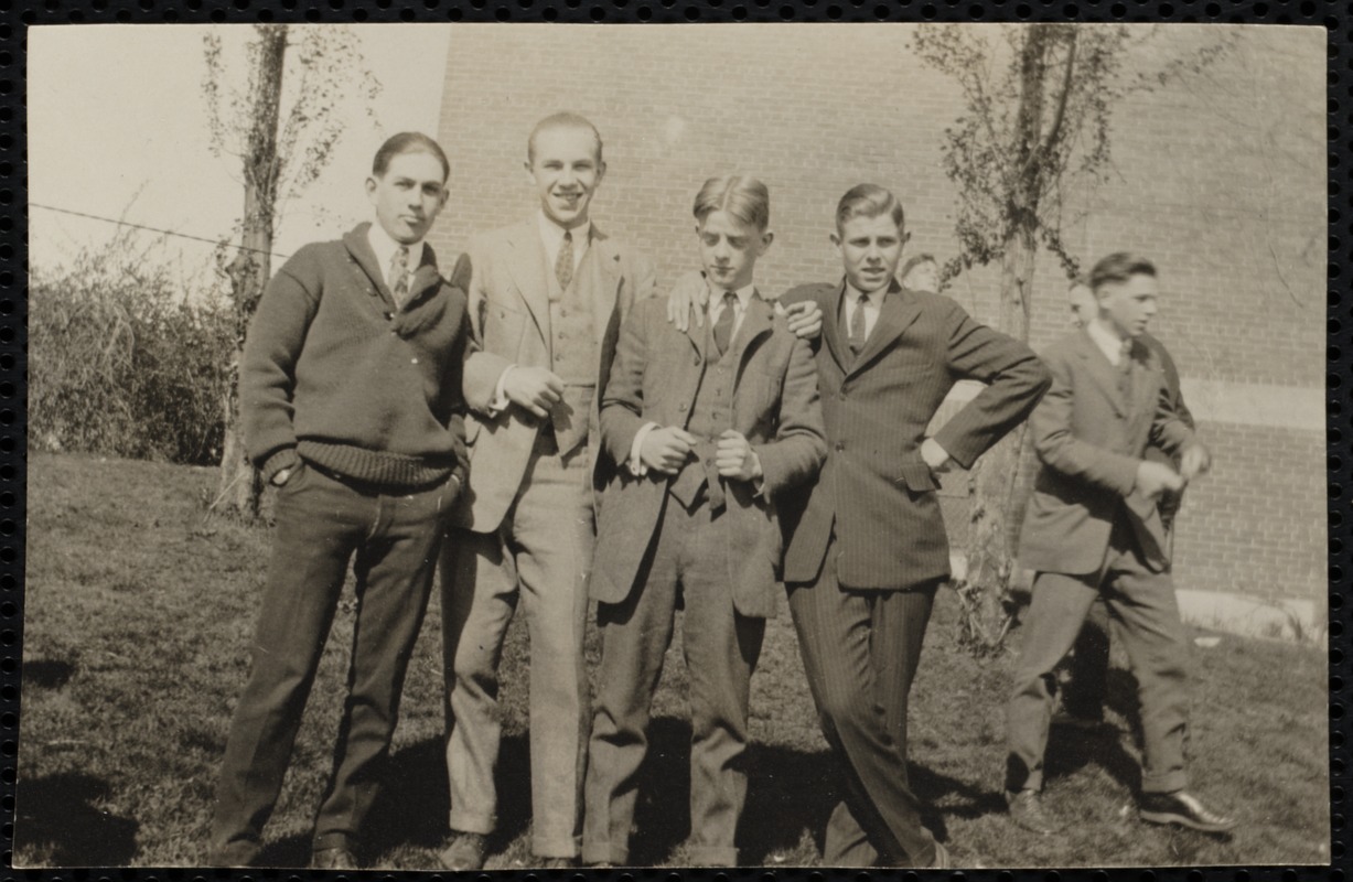 Four young men posing, another behind them