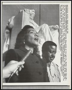 Mrs. Coretta King, widow of the late Dr. Martin Luther King Jr., and Rev. Ralph Abernathy speak to Poor People's Campaigners 5/30 at the base of the Lincoln statue in the Lincoln Memorial. A heavy downpour caused postponement of a memorial service for Dr. King on the steps of the shrine. Mrs. King was scheduled to narrate Aaron Copland's "Lincoln Portrait" with the Washington National Symphony.