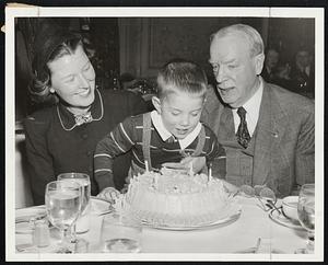 Fourth Birthday Blow-Off. Former Mayor Frederick W. Mansfield, right, encourages his grandson, Matthew Mansfield of Vienna, Va., during the candle-blowing ceremomy at the latter's birthday party at the Copley Plaza. At left is Mrs. Walter Mansfield, Matthew's mother. His father, Lt. Walter Mansfield, USMC, is serving in the Middle East area.