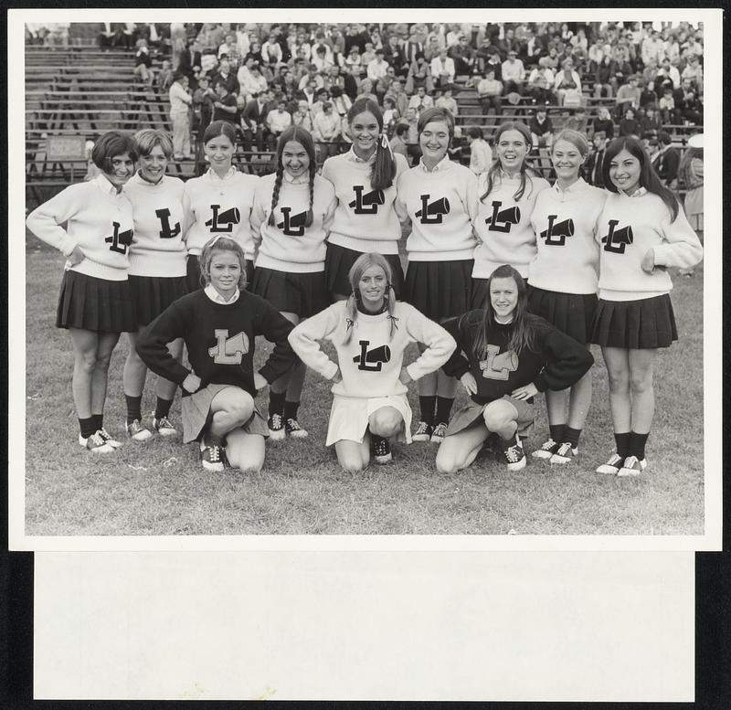 Ready for action is this group of smiling Lowell High School cheerleaders. Front, from left, Liz Martin, Carol Magowan and Barbara Burns. Rear, Ava Bahou, Chris Gendron, Gayle McAndrew, Debbie Bacos, Debbie O’Donnell, Jackie Welcome, Dotty McGuire, Batty Matthews and Linda Nazarian.