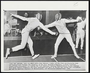 Near Miss--John Mooney, right, of New York accidentally runs his blunted foil through the clothing of the Rev. Patrick O’Donnell, a Roman Catholic priest from Cincinnati, O., during the U.S. National Fencing Championships in Los Angeles this week. Father O’Donnell was only scratched and went on to win the match. The tournament was won by Lawrence Anastasi of Philadelphia.
