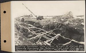 Contract No. 80, High Level Distribution Reservoir, Weston, looking southeast from a point 30 feet left of Sta. 899+/- showing overhang top material, high level distribution reservoir, Weston, Mass., Mar. 6, 1940