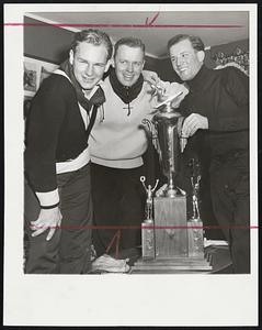 Austrian Ski Champion, Othmar Schneider (risght), displays trophy he won Saterday by defeating 68 rivals in 40-gate downhill course at Big Bromley in Manchester, Vt., to U. S. Olympic team members Dave Lawrence (left) and Joe Jones, former Middlebury College ski coach.