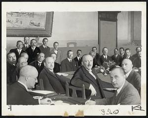 When the Locarno pact was signed, Oct. 16, 1925, existing frontiers were guaranteed, and immediately afterward Germany entered the League of Nations. This pact and the Versailles treaty were violated when Reichsfueher Hitler announced reoccupation of the Rhineland by Nazi troops. Signing of the Locarno pact is shown. Among those representing the powers at Locarno were (left to right) Dino Grandi, Italy (with beard), now ambassador to Great Britain; Hans Luther (wearing glasses), now German ambassador to the United States; Benito Musoslini (seated in background): Gustave Stresemann (facing camera in front and to right of Mussolini), then German foreign minister; Sir Austen Chamberlain (wearing monocle), England, and (seated at table at extreme right, with cigarette), Aristide Briand, France.