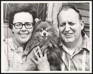 Three Happy Smiles. Ltor.- Mrs. Rachel Henaire - 35. "Suzie"- Pomeranian dog + Armand Henaire - 44 - of Worcester. Winner - $50,000 Mass. State Lottery drawing. Henaire works at Harvey Friend Co, Worcester