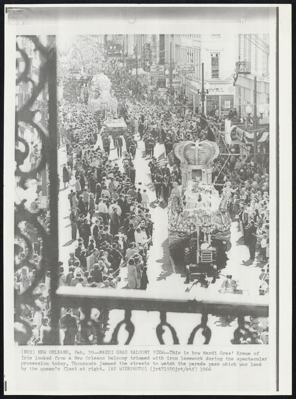 Mardi Gras Balcony View--This is how Mardi Gras' Krewe of Iris looked from a New Orleans balcony trimmed with iron lacework during the spectacular procession today. Thousands jammed the streets to watch the parade pass which was lead by the queen's float at right.