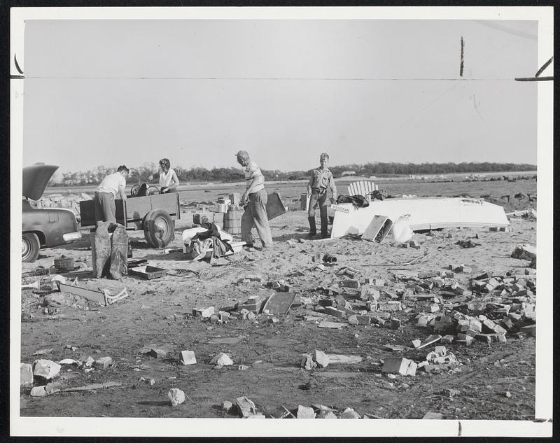 This Makes Twice -- A Roslindale family salvages a few bits from their summer home in Crescent Beach, Mattapoisett. Left to right: Fred C. Wiedeman, Jr., his wife, his father, and his son, Fred 3d. They went through the same thing at the same spot after the 1938 hurricane.