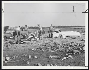 This Makes Twice -- A Roslindale family salvages a few bits from their summer home in Crescent Beach, Mattapoisett. Left to right: Fred C. Wiedeman, Jr., his wife, his father, and his son, Fred 3d. They went through the same thing at the same spot after the 1938 hurricane.