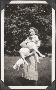 A woman holding a goat