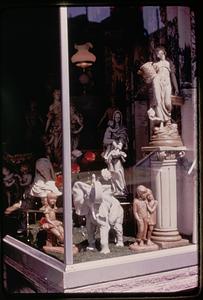 Statues displayed in a store window