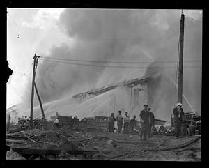 Firefighters using water hoses on an unidentified fire
