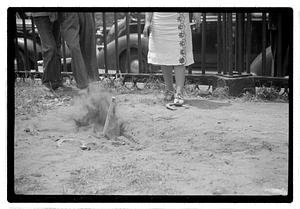 Two young women playing horseshoes