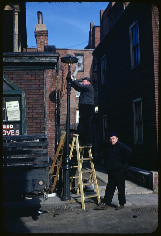 Men converting gas lamp, Roxbury