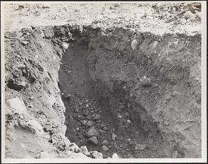 Pit shot of water pumped out showing gravel, rocks and sandy material