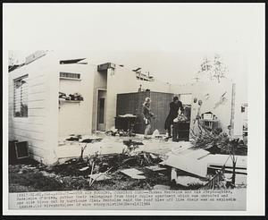 Open Air Housing, Courtesy Cleo--Thomas Mentelos and his stepdaughter, Madeleine O'Brien, gather their belongings from their duplex apartment which was unroofed and one side blown out by hurricane Cleo. Mentelos said the roof blew off like their was an explosion inside.