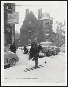 Storm Traveler-Russell E. Haddleton uses skis to swing along St. Botolph street while on a round of business calls in yesterday's storm.