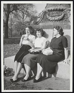 Getting a Tan in the November sun which sent the temperature to an all-time November high of 83 are these girls seated at the base of a statue in the Public Garden. Left to right, Claire Gunning, Janet Clark and Rita Pasqualone.
