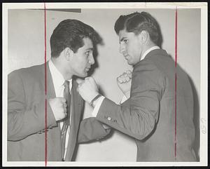 Clouting Cousins are Phil Rugnetta (left) of Dorchester and an outstanding amateur heavyweight, squaring off, but only for the benefit of the photographer, with his cousin, former English High athlete Ted Carengelo, who for the second straight year won the Colgate heavyweight championship.