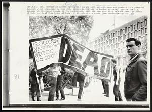 A Protest in London -- Protesters parade with anti-Vietnam war posters in a peaceful demonstration organized by Americans living in Britain in London Saturday. That's the U.S. embassy in Grosvenor Square in the background, with the American flag at half staff in honor of U.S. war dead this Memorial Day.