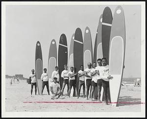 Surf Boards at Salisbury are new life saving device for the state-controlled beach which this year will receive 1,500,000 visitors. Kneeling is Gilbert J. Champagne of Newton who instructed life guards in use of the surf boards.