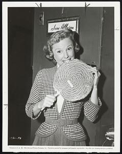 June Allyson collected this king-size all-day sucker as one of many birthday gifts presented to her at Universal-International during shooting of "The Shrike." June stars with Jose Ferrer in the Pulitzer Prize play as brought to the screen by U.I.
