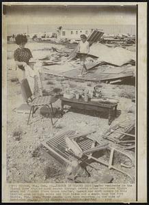 Search in Gladys Debris-Two residents in the Signal Cove trailer park search through debris after hurricane Gladys winds had flattened there house trailer. Damage was most severe in this trailer area as gale winds and high tides cut a swath near the Port Richie, Fla. area. Three deaths have been reported in the wake of hurricane Gladys.