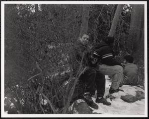 Torin, Jamie, and Reji Mathew sitting in the woods