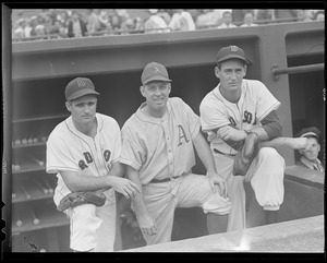 Bobby Doerr and Ted Williams pose in dugout with Athletics player