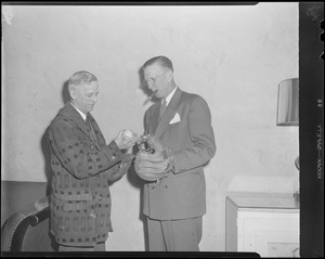 Two men with mitts and ball, possibly former players