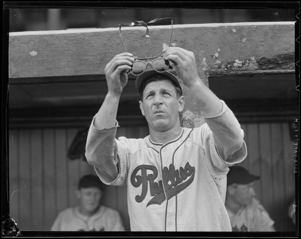 Philadelphia Phillies player examines his glasses