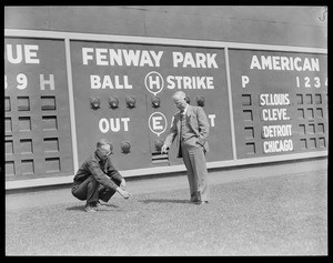 Inspecting the grounds in front of Fenway scoreboard