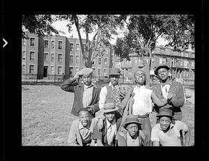 Eight young men posing in a park