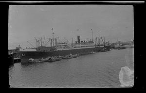 Naval ship surrounded by other boats