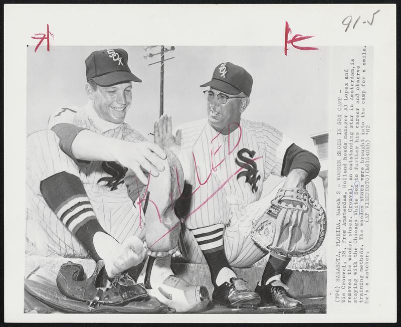 Wooden Shoes in Sox Camp - Wim Crouvel, 18, from Amsterdam, Holland heeds manager Al Lopez and removes the wooden shoes. Crouvel, an outstanding star in Amsterdam, is staying with the Chicago White Sox to further his career and observe training methods. The wooden shoes were brought into the camp for a smile. He's a catcher.