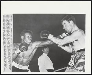 Curvis Takes One on Chin--World welterweight champion Emile Griffith lands a left jab to the chin of British champion Brian Curvis during their title fight tonight at London's Empire Pool. Griffith easily retained his title over 15 rounds and floored Curvis three times during the fight. English referee Harry Gibbs, the sole official, declared Griffith the winner.