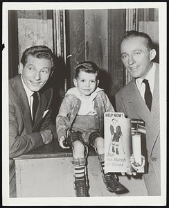 “Mr. Personality,” the 1954 March of Dimes Poster Boy, met two famed personality boys of the entertainment world during his recent visit to Hollywood when he visited Danny Kaye (left) and Bing Crosby on the set of “White Christmas,” in production at the Paramount studio. Debby Dains, the four-year-old lad from Gooding, Idaho, made nationwide personal appearances during January as part of his contribution to the anti-polio fund raising drive.