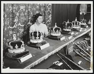 Reproductions of British crown jewels are displayed at the Travelcade at Mechanics Building. The exhibit is at the British Overseas Airways Corp. booth. Showing off the display is Eve Robinson Popkin of Brookline.