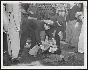 Injured Striker – Picket Lester McCarty, 30, of Stanley street, Dorchester, lies on the ground at the entrance to the Eastern Co. bus yard in Quincy after being struck by a car containing non-strikers. McCarthy was taken to the Quincy Hospital for treatment of head injuries.