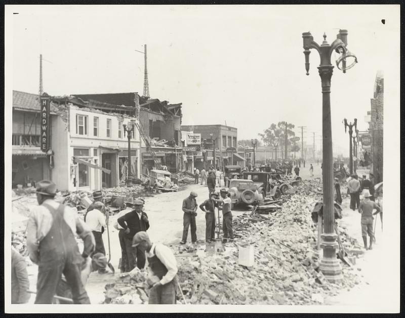 Compton Clears Main Street After Quake. Clearing away debris on the Main Street of Compton, Calif., the day after the earthquake, March 10.