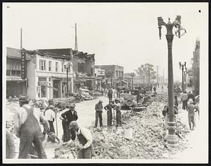 Compton Clears Main Street After Quake. Clearing away debris on the Main Street of Compton, Calif., the day after the earthquake, March 10.