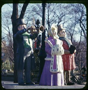 Figurines of carolers and a trumpeter