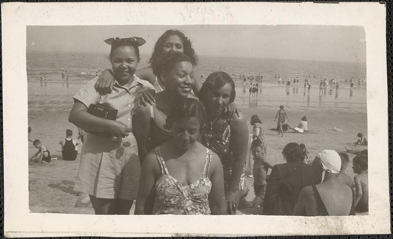 Five women pose at the beach