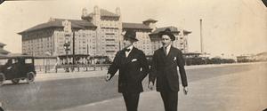 Two unidentified men walking by the Hotel Galvez, Galveston, TX