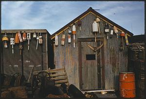 View of shack decorated with buoys
